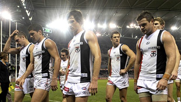The St Kilda players walk dejectedly from the field at Etihad Stadium after yesterday’s defeat at the hands of Essendon.