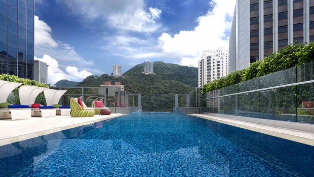 Guests can swim to the glass-bottomed deep end of the Hotel Indigo's rooftop pool for stellar views of The Peak.