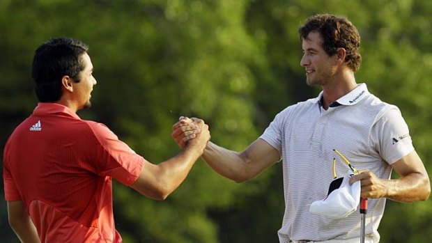 Well done: Jason Day (left) and Adam Scott congratulate each other after coming joint second in the US Masters.