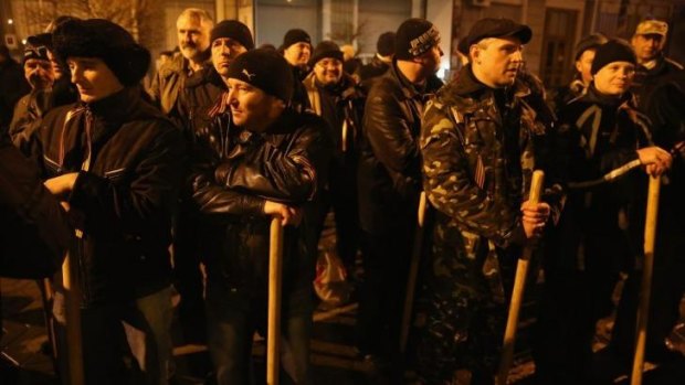 Pro-Russian men armed with staves gather outside Crimea's regional parliament building  in Simferopol, Ukraine, on Thursday, after armed men seized the building and raised the Russian flag.