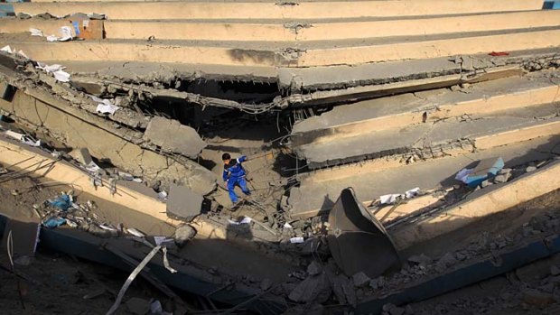 Among the wreckage ... a Palestinian boy.