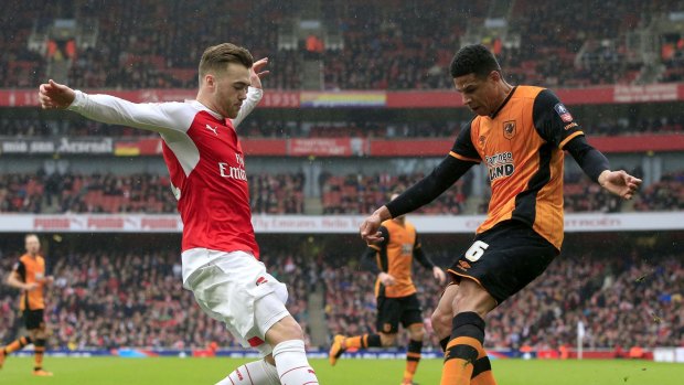 Hull City's Curtis Davies and Arsenal's Calum Chambers battle for the ball.
