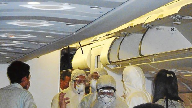 Passengers were placed in quarantine after Chinese officials in anti-contamination suits boarded this plane on  its arrival in Shanghai.