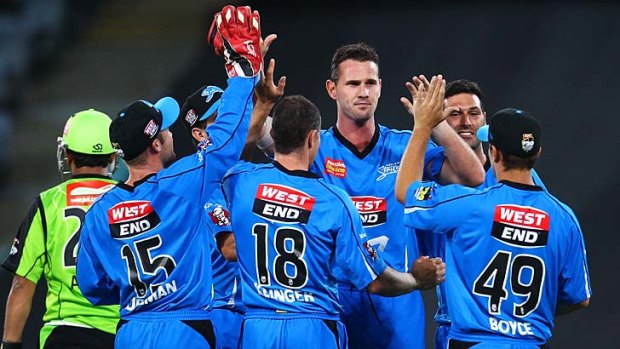 Celebrations ... Shaun Tait of the Strikers is congratulated by his teammates after claiming the the wicket of Azhar Mahmood.