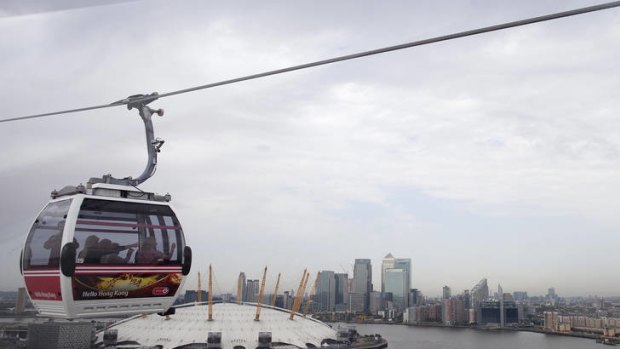 An Emirates Air Line cable car carries passengers across the River Thames on the opening day of the new transport link in London.