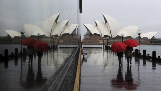 On such a winter's day ... unrelenting grey skies and near continuous rain dampened long weekend plans for many Sydneysiders but this couple ventured outdoors for a stroll, regardless of the weather.