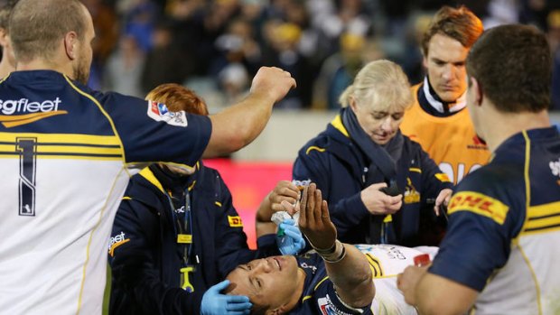 Christian Lealiifano gets high fives from his teammates while being taken off injured after the round 11 Super Rugby match between the Brumbies and the Waratahs at Canberra Stadium.