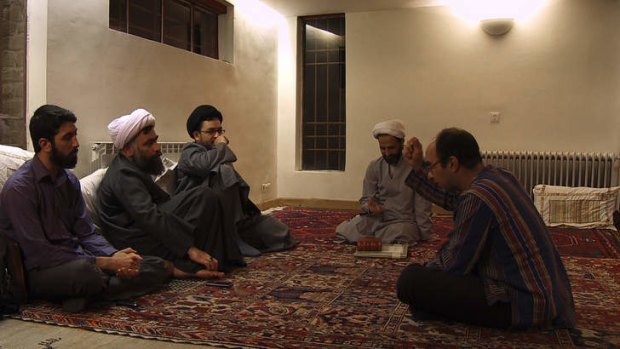 Mehran Tamadon, right, tries to convince his guests of the merits of a secular society in his film <i>Iranian</i>, screening at MIFF 2014.