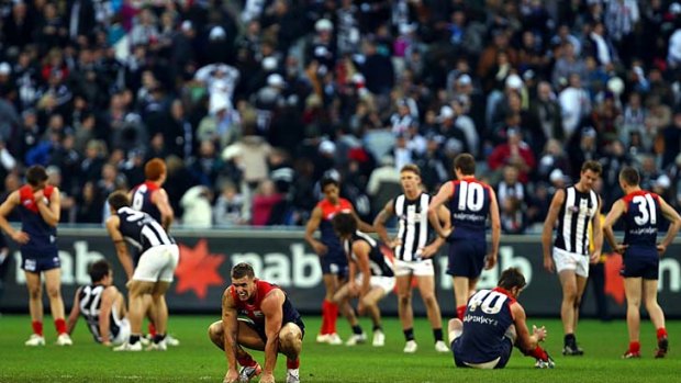 Melbourne and Collingwood contemplate their draining draw, round 12, 2010.