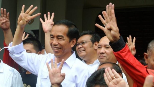 Joko Widodo holds up four fingers to depict his party's position on the ballot paper.