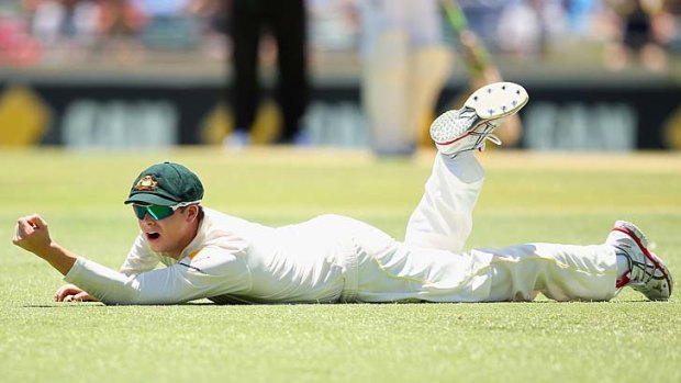 Steve Smith dives in vain to try and catch a snick from Alastair Cook.
