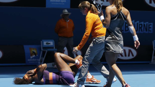 Chair umpire Kerrilyn Cramer and her opponent come to the aid of Serena Williams after she fell heavily.