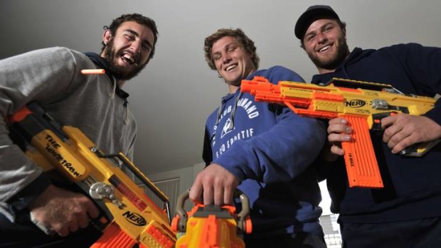 Brumbies players Nic White, Micheal Hooper and Dan Palmer relax after training in their Kingside apartment.