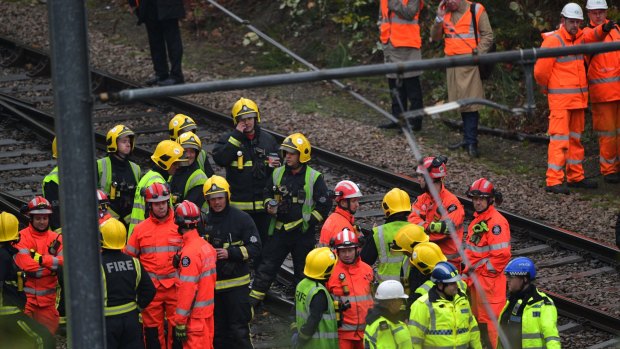 Emergency service workers gather at the scene.