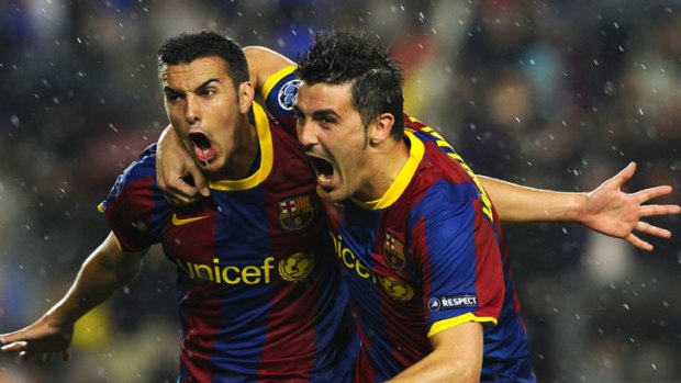 On their way ... David Villa, right, joins Pedro to celebrate after the winger had put Barcelona 1-0 up.