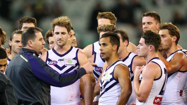 MELBOURNE, AUSTRALIA - JUNE 24:  Danyle Pearce of the Dockers, Michael Barlow and the Dockers listen to Ross Lyon, coach of the Dockers speak during a quarter time break during the round 14 AFL match between the Collingwood Magpies and the Fremantle Dockers at Melbourne Cricket Ground on June 24, 2016 in Melbourne, Australia.  (Photo by Scott Barbour/Getty Images)