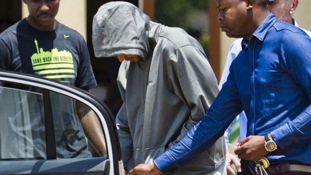 Murder charge ... Olympic athlete Oscar Pistorius leaves the Boschkop police station.