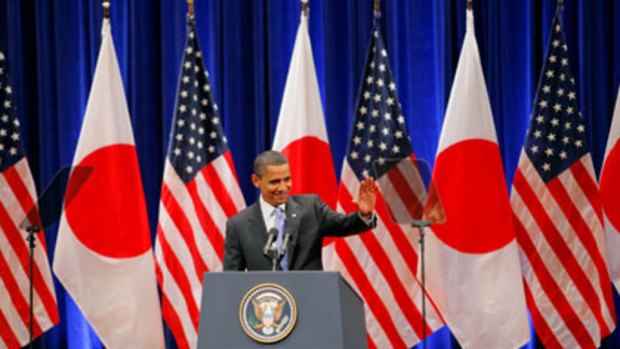 Flying the flag... US President Barack Obama speaking at the Suntory concert hall in Tokyo yesterday ahead of his first official visit to China.