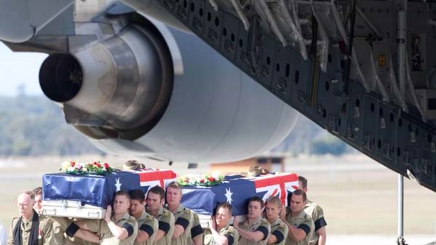 Last post... the bodies of sappers Jacob Daniel Moerland, 21, and Darren James Smith, 25, are carried from the plane.