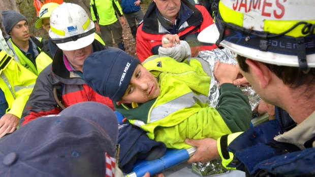 Luke Shambrook holding the hand of a policeman was taken to be reunited with his parents.