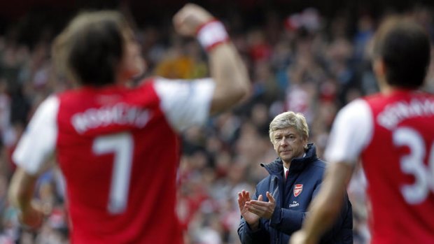 Arsenal manager Arsene Wenger applauds as Czech Republic midfielder Tomas Rosicky (left) celebrates scoring a goal against Tottenham.