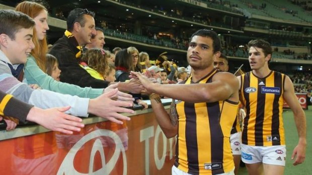 Cyril Rioli high-fives supporters after the game.