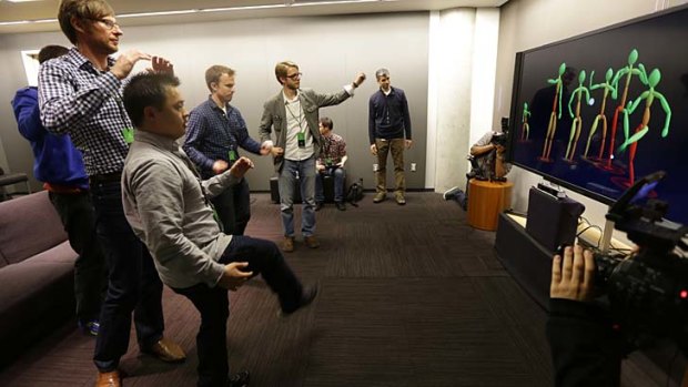 Journalists try out the new Kinect controller at the Xbox One launch.