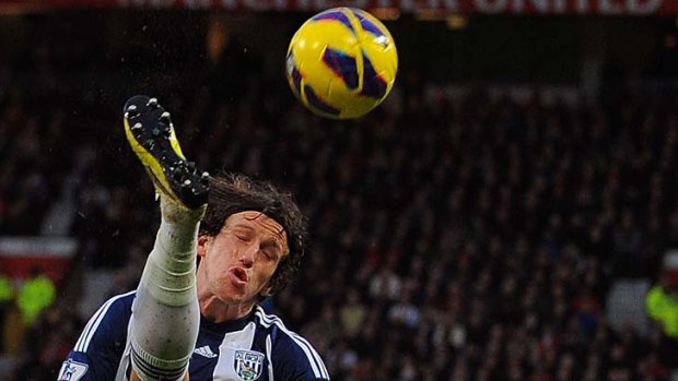 Head over heels ... West Brom's Billy Jones clears.