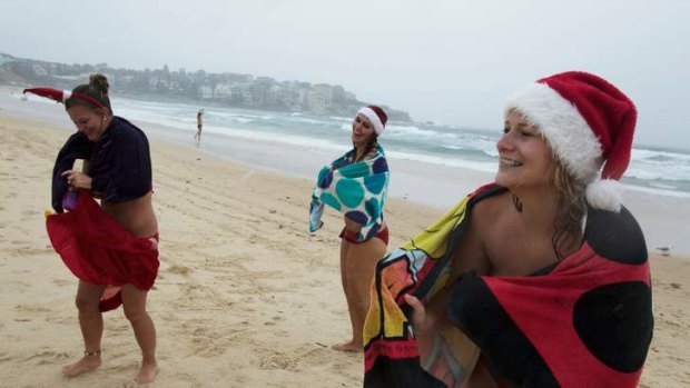 English back packers Katy Richards 24, Claire Ashdown 25 and Jo Stevens 25 go for a swim on Bondi Beach on Christmas Day.