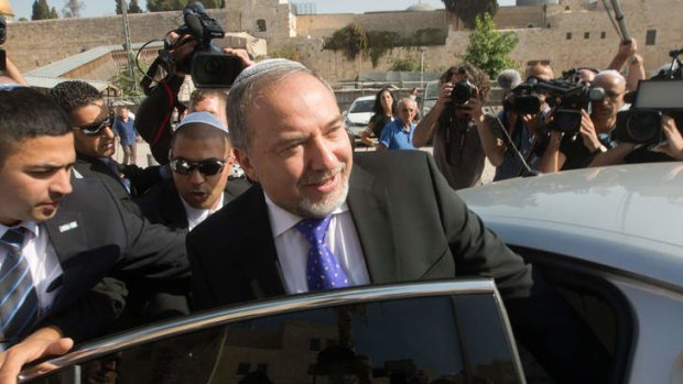 Former Israeli Foreign Minister Avigdor Lieberman enters his car after visiting the Western Wall following the verdict in his trial in Jerusalem.