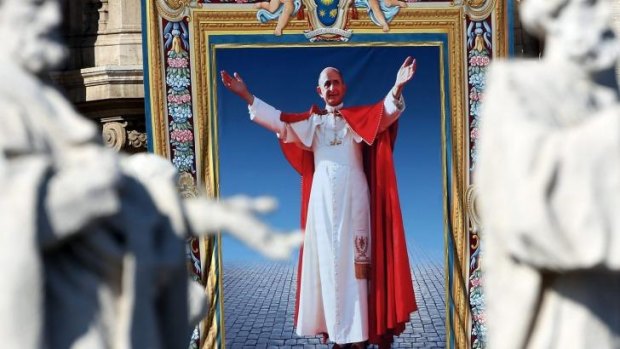 A tapestry depicting Pope Paul VI hangs on the balcony of St Peters basilica during the holy mass for the closing of Extraordinary Synod held by Pope Francis.