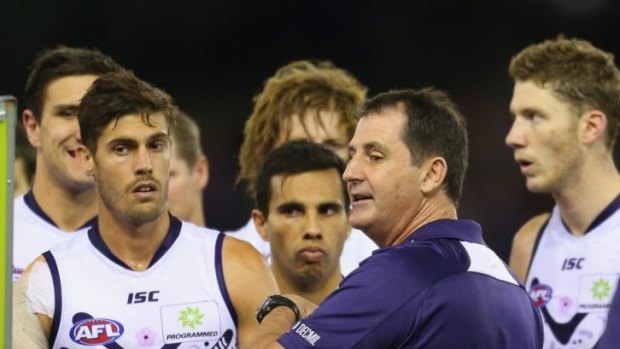 Fremantle coach Ross Lyon has a word with his players during a break.