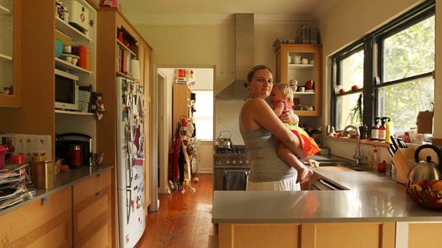 Taken for a ride: Alex Lenane and daughter Chloe in their incomplete kitchen.