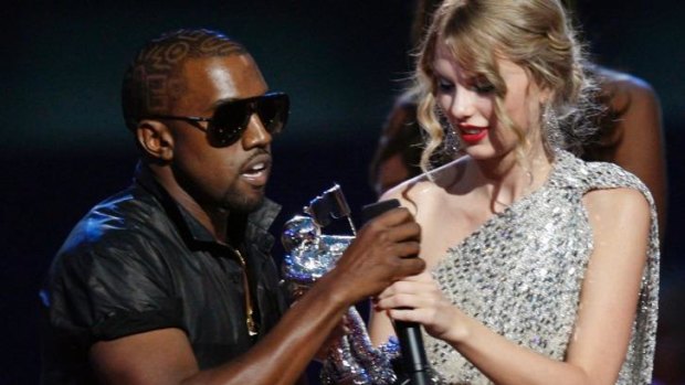 Kanye West takes the microphone from best female video winner Taylor Swift as he praises the video entry from Beyonce at the 2009 MTV Video Music Awards.