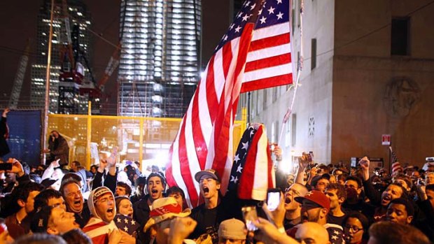 With the new One World Trade Centre building in the background, second left, a large, jubilant crowd reacts to the news of Osama bin Laden's death at the corner of Church and Vesey Streets, adjacent to ground zero.
