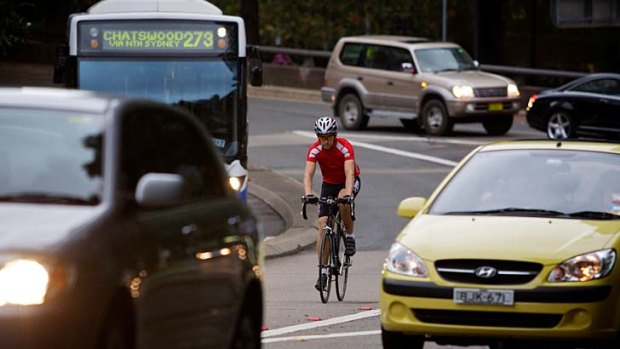 A cyclist braves the traffic in Sydney yesterday.