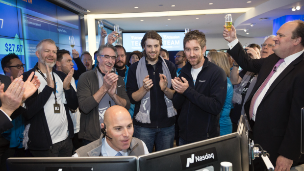 Atlassian founders Scott Farquhar and Mike Cannon-Brookes watch as shares in their company begin trading in New York.