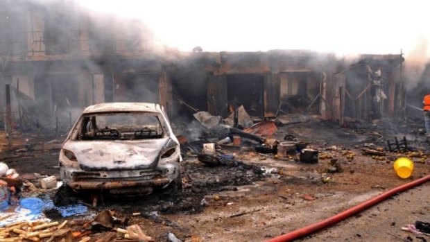Carnage: burnt out shops at Terminus market in Jos after the double bombing.
