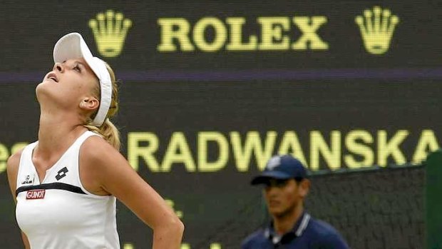Agnieszka Radwanska of Poland celebrates after defeating Li Na of China in their women's quarter-final tennis match at the Wimbledon Tennis Championships.