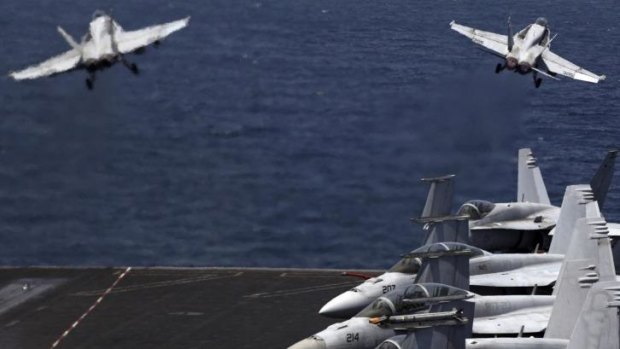 Two F/A-18 fighter jets have crashed into the western Pacific Ocean after after taking off from the aircraft carrier USS Carl Vinson. Here two fighters take off for a mission in Iraq from the USS George HW Bush in the Persian Gulf.