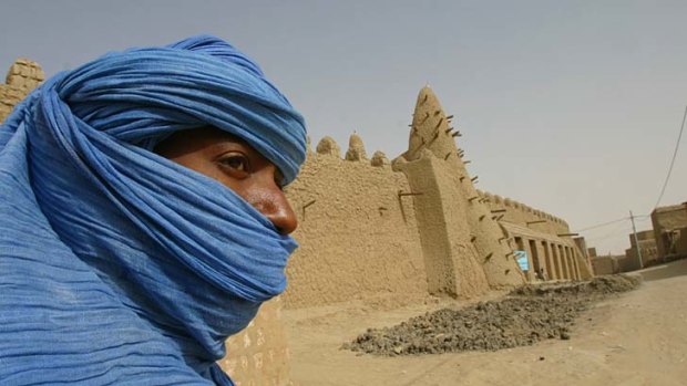 Thousands flee &#8230; a Tuareg nomad near a mosque in Timbuktu, where Islamist radicals have taken over.