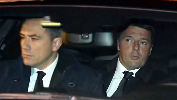 Italian Premier Matteo Renzi, right, arrives at the presidential palace to tender his resignation. 