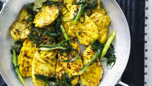 Turmeric fish with spring onion and dill.