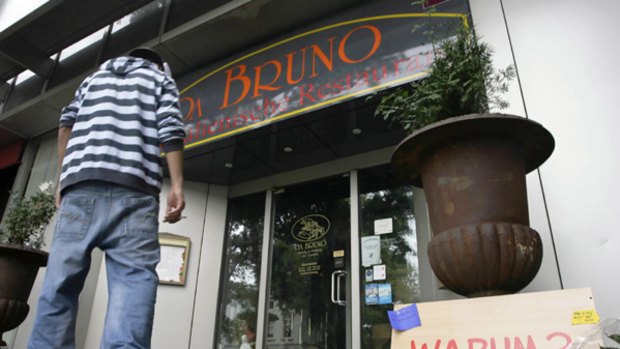 The Italian restaurant in Duisburg, Germany, where six men were shot dead in 2007. The plaque reads "Why?"