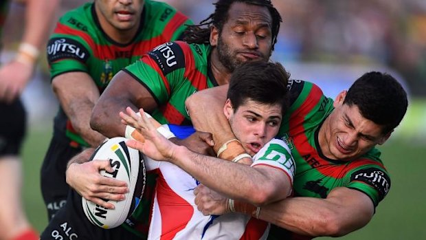 Tough going: Jake Mamo is wrapped up by the Souths defence. 