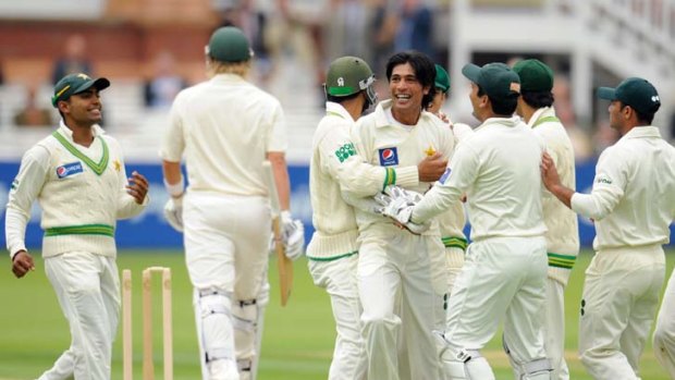Questions &#8230; Pakistan's Mohammad Amir is congratulated after dismissing Australia's Shane Watson during the first Test at Lord's in 2010. Police now suspect there were attempts to fix the game.