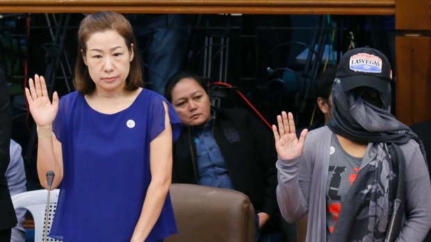 Choi Kyung-jin, left, the widow of South Korean businessman Jee Ick-joo, and their former housekeeper Marissa Morquicho take their oaths at the start of the Philippine Senate probe into his killing.