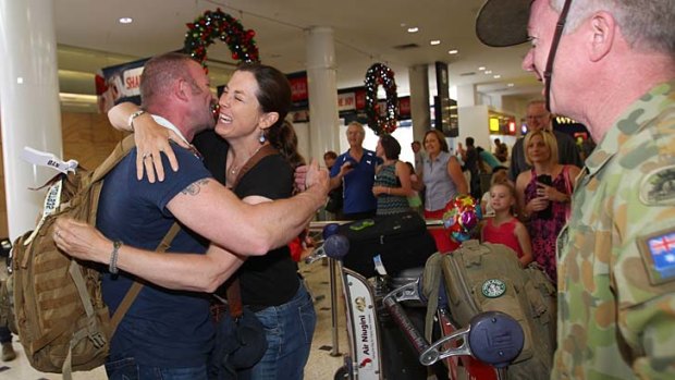Major Jon Lane takes his wife, Sally Beaumont, in his arms in a huge airport welcome.