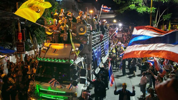 Anti-government protesters ride in a truck as they occupy the Finance Ministry and the Foreign Ministry in a bid to oust the current government of Yingluck Shinawatra in Bangkok.