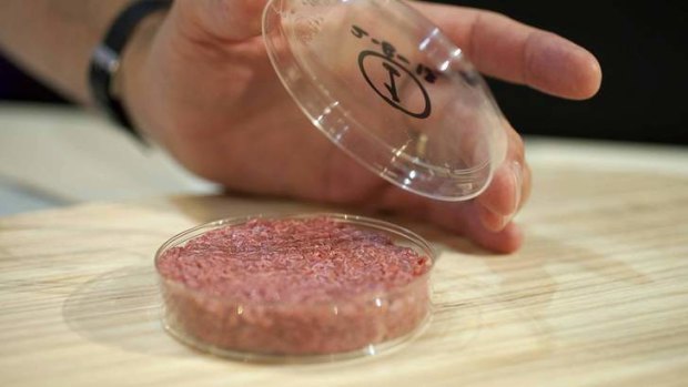 Professor Mark Post shows the world's first lab-grown beef burger during a launch event in west London.